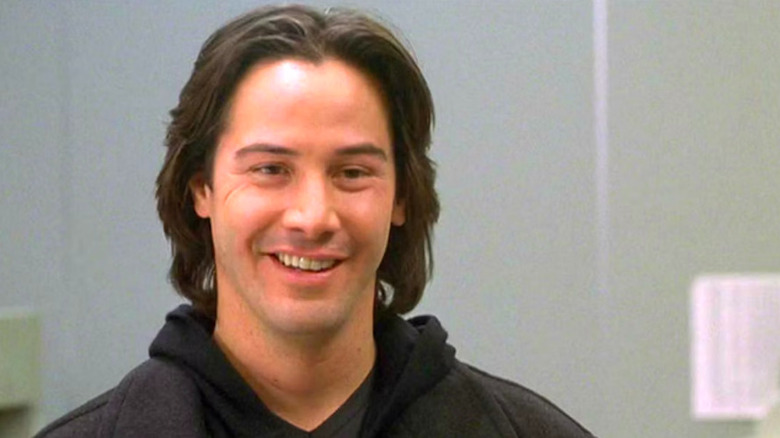 Keanu Reeves smiling in The Watcher