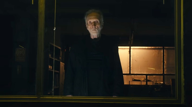 John Kramer stares menacingly out a window in Saw X