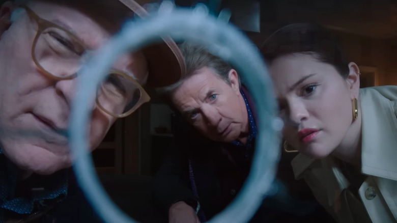 Steve Martin, Selena Gomez, and Martin Short look at a bullet hole in a window in Only Murders in the Building season 4