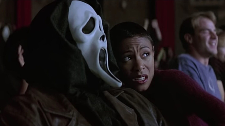 Ghostface and Jada Pinkett-Smith watch Stab in Scream 2