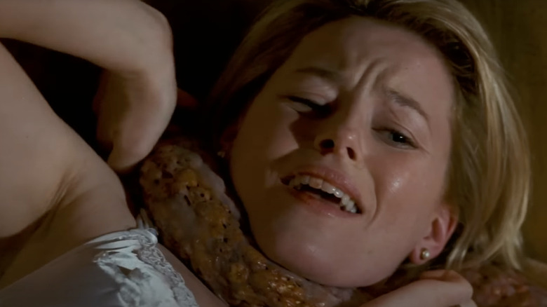 Starla fights an organism in Slither