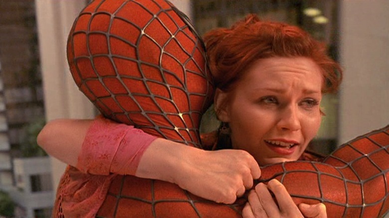 Mary Jane clinging to Spider-Man mid-air