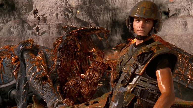 Rico next to an exploded bug in Starship Troopers