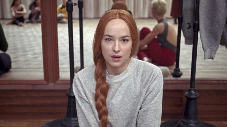 Dakota Johnson sitting on floor of ballet studio in Suspiria