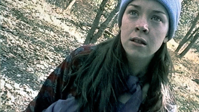 Heather Donahue standing in the woods in The Blair Witch Project