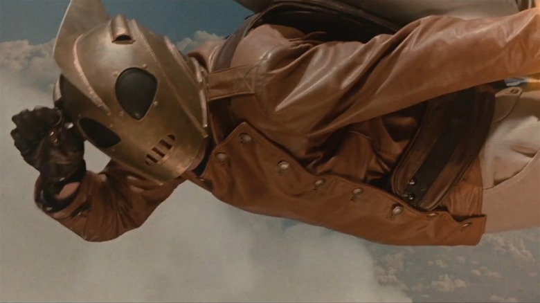 The Rocketeer saluting while flying