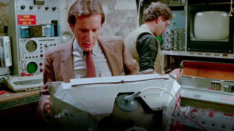 Max looks at a monitor in Videodrome